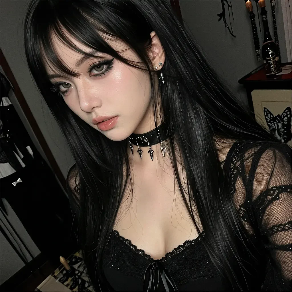 Black-haired woman in gothic lace top and spiked choker with cross earrings, dark room